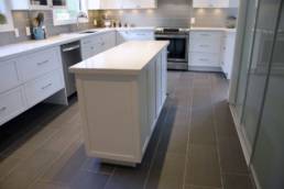 large porcelain tiles in a rich grey color complement the stainless steel appliances