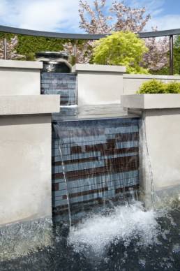 Cascading water over a modern tiered water feature