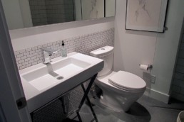 all white bathroom with a dark concrete floor create a modern look