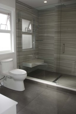 bathroom floors lined with a grey porcelain tile made to look like slate