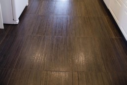 rich chocolate brown porcelain tile mimic hardwood floors